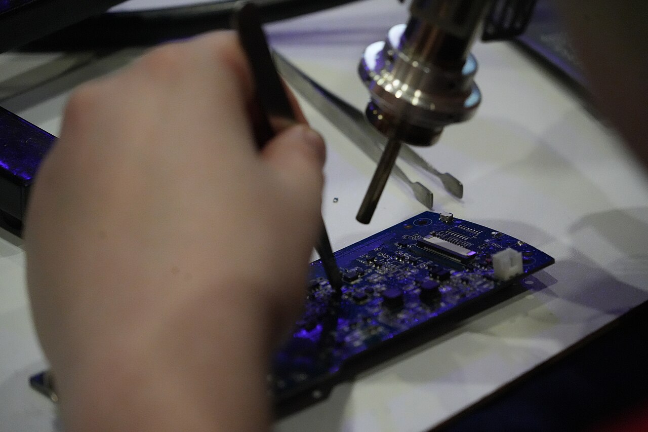 Board-level work happens on a controlled bench, not at a kitchen table.